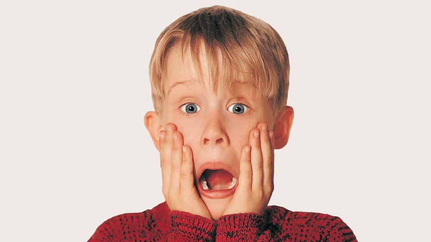 Macaulay Culkin, as Kevin McAllister, holds his hands to his face and screams in Home Alone.