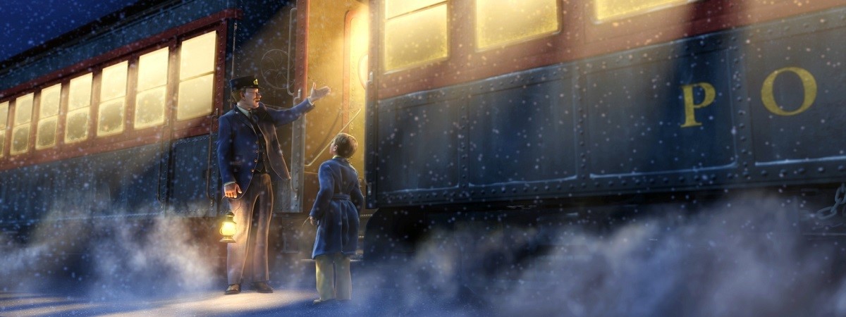 The ticket master and a young boy stand talking outside of The Polar Express train.