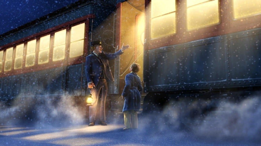 The ticket master and a young boy stand talking outside of The Polar Express train.