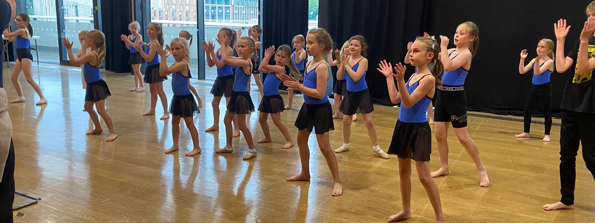 Young people perform as part of a dance workshop.