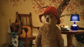 Paddington Bear stands in the hallway of the Browns' house in a still from Paddington.