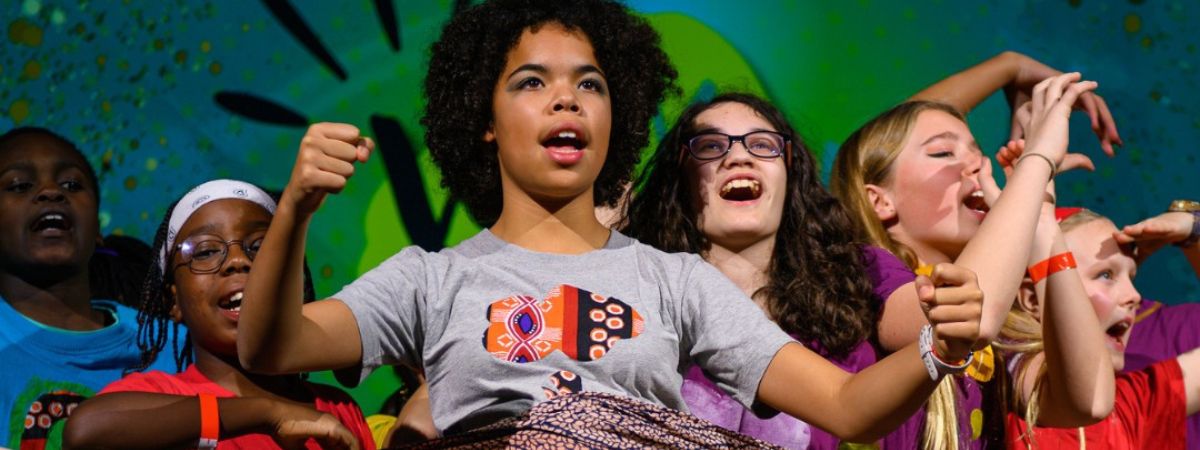 A group of school children perform in a promotional image for Coram Shakespeare Schools Festival.