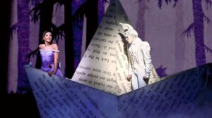 An image of Alice and the White Rabbit in a paper boat in a still from Royal Ballet's Alice's Adventures In Wonderland.