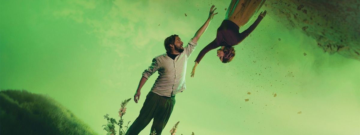 Two people reach beyond each other in a promotional image for English Touring Opera's Orpheus & Eurydice.