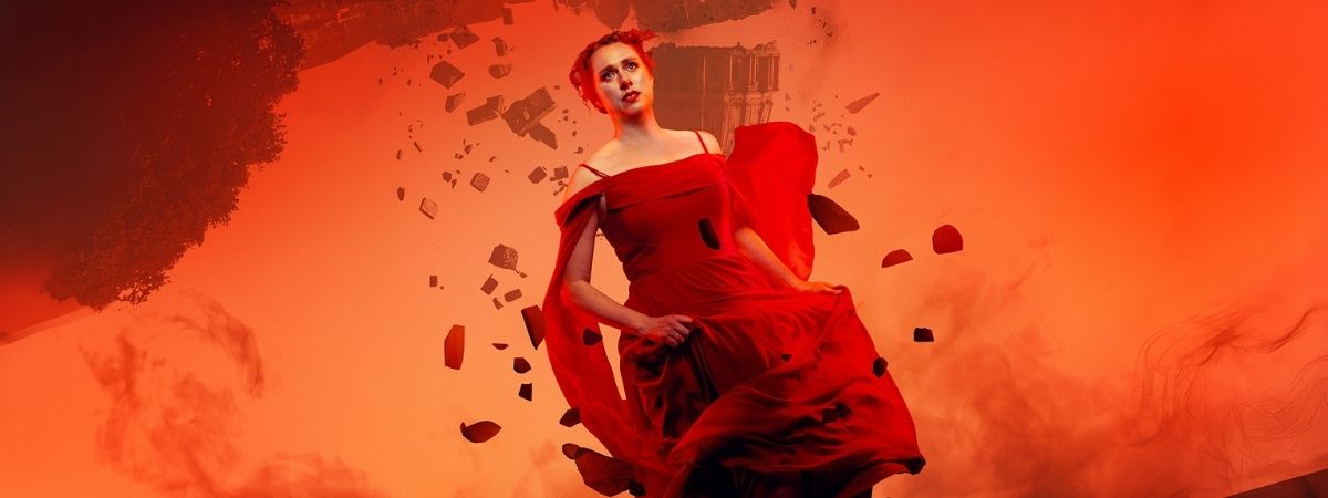 A person wearing a red dress runs from a falling building in a promotional image for English Touring Opera's Tosca.